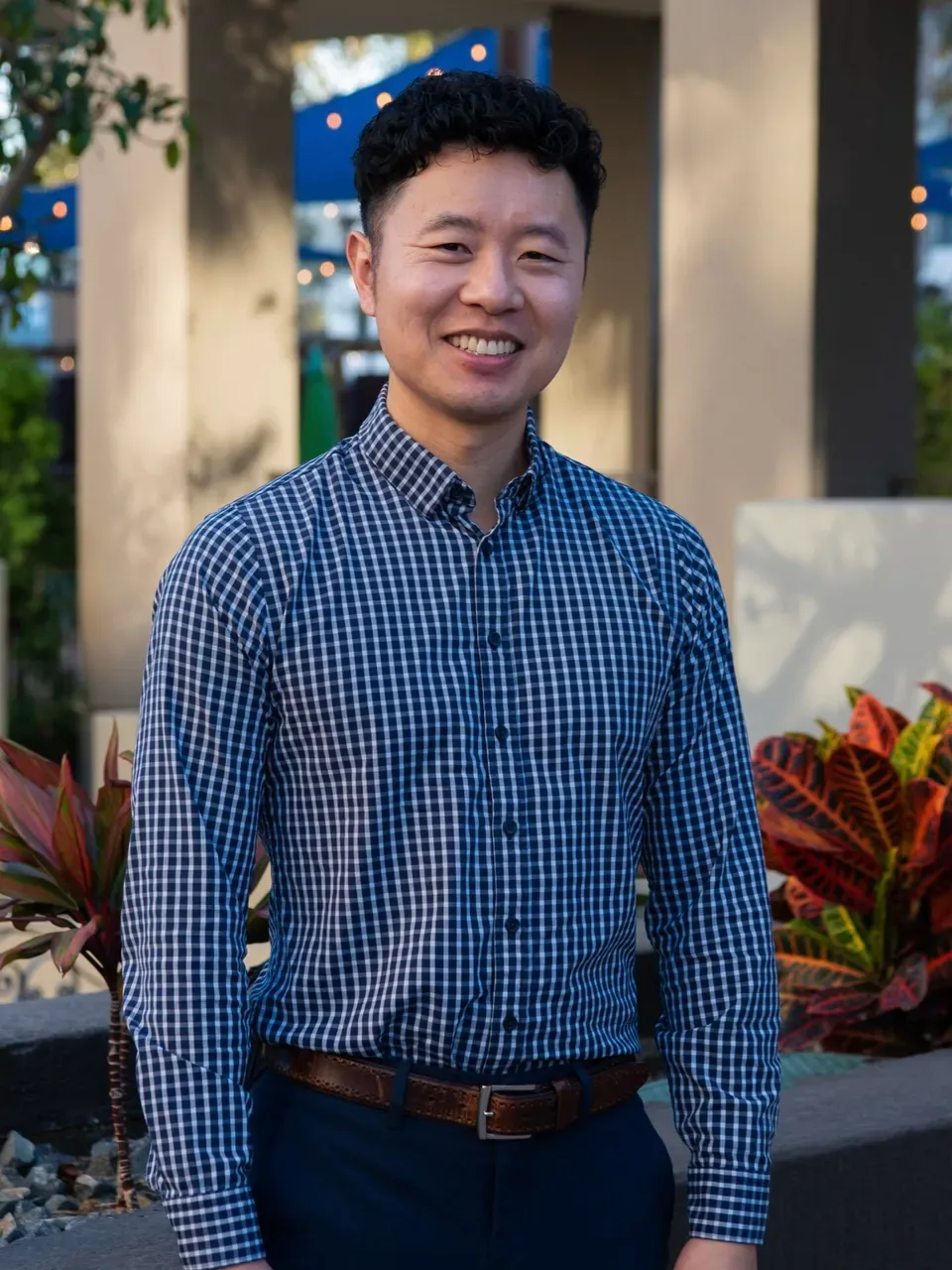 Ronnie F. smiling in a checked shirt