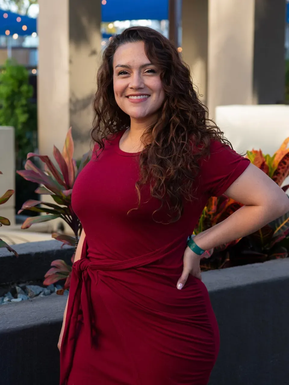 Suzanne R. smiling in a red dress
