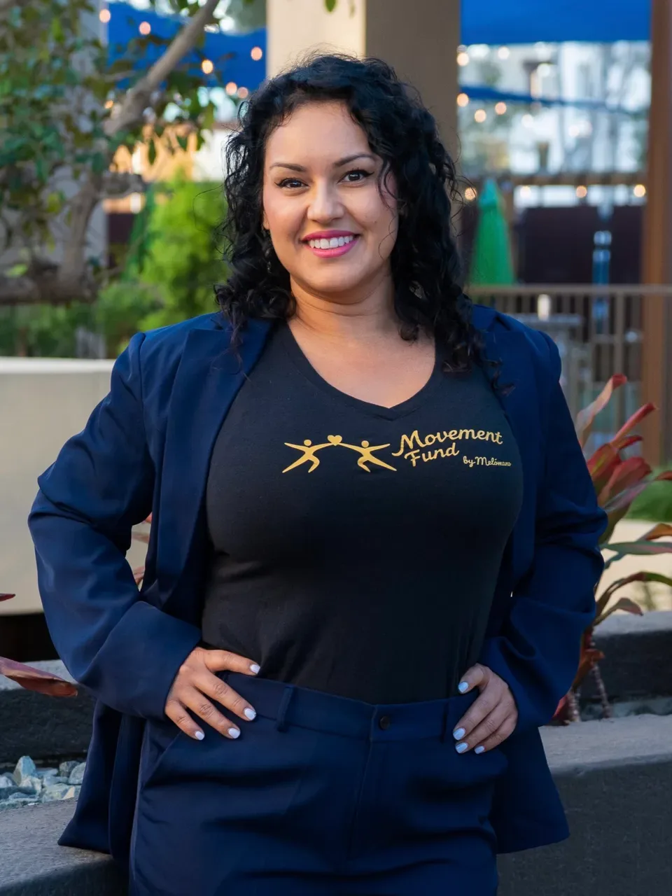 Diana T. smiling in a Movement Fund t-shirt and navy blazer